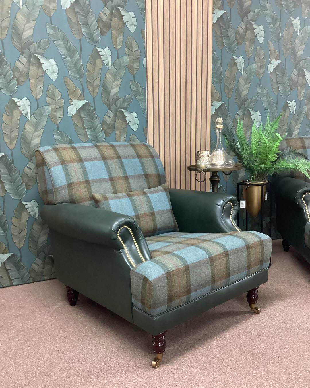 Pair of bespoke armchairs by a stone fireplace